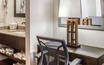 Work desk and guest bathroom at Rodeway Inn Milford.