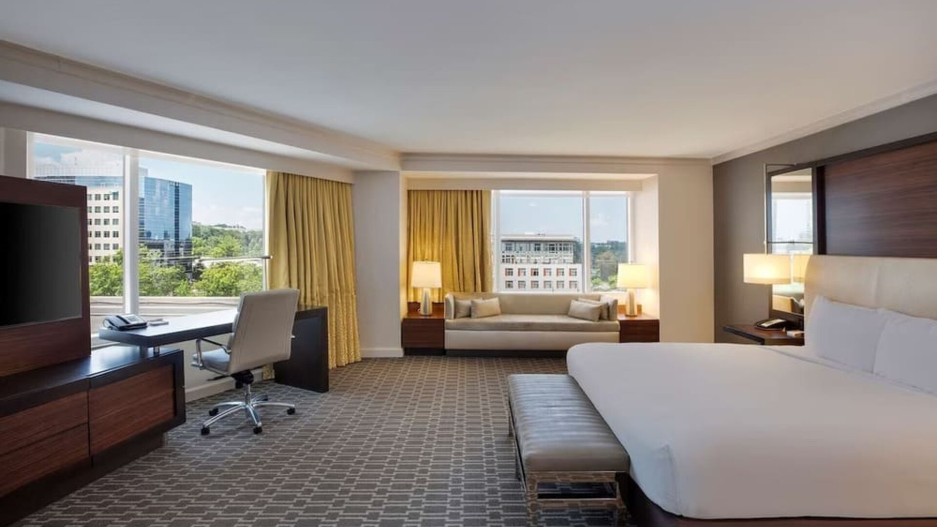 Spacious day use room with work desk and sofa at Hilton McLean Tysons Corner.