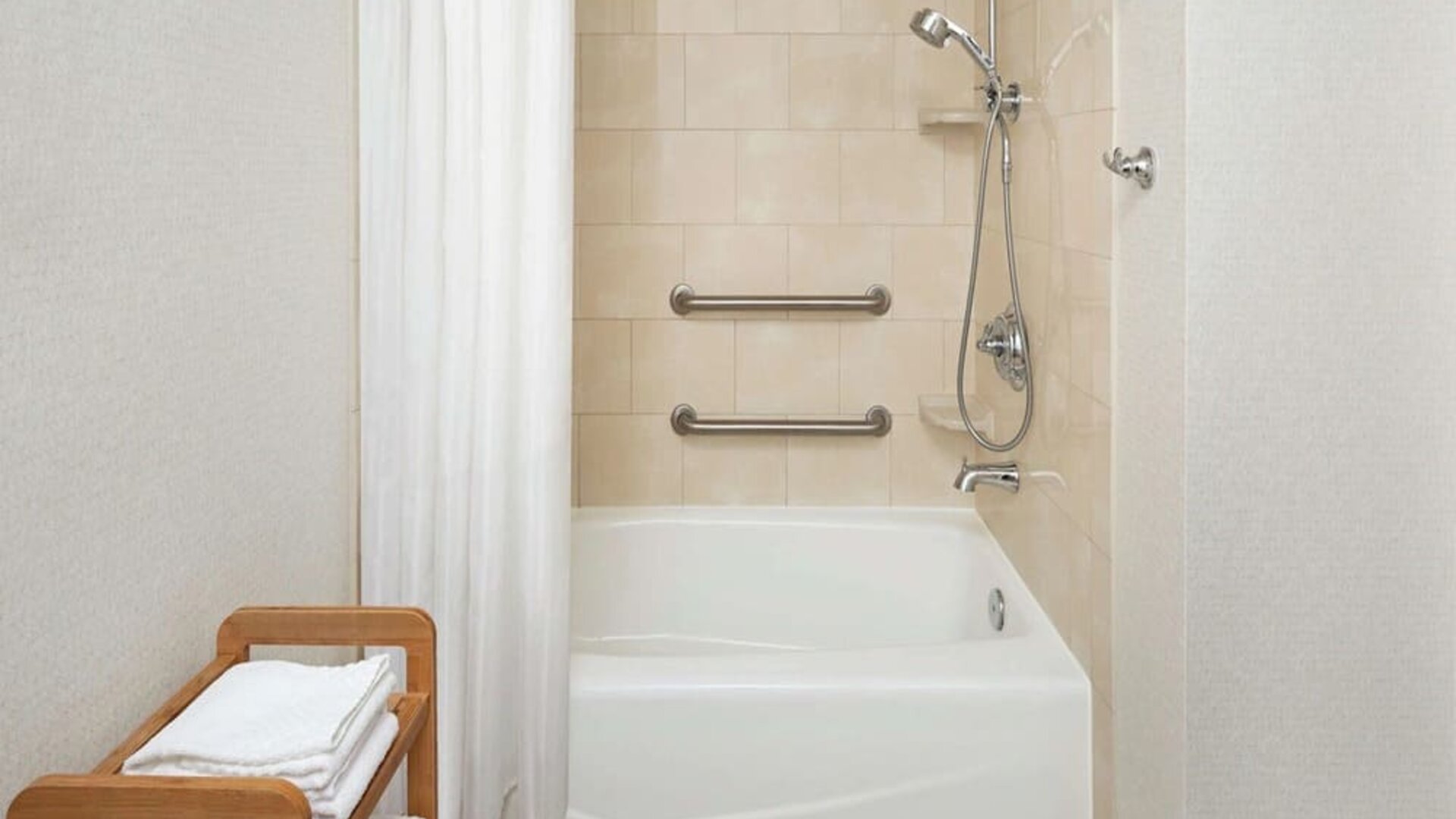 Guest bathroom with shower and tub at DoubleTree Raleigh Durham Airport At Research Triangle Park.