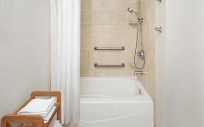 Guest bathroom with shower and tub at DoubleTree Raleigh Durham Airport At Research Triangle Park.