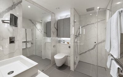 Guest bathroom with shower and guest bathroom at Tower Suites Hotel by Blue Orchid.
