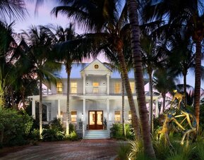 Hotel exterior at dusk at Parrot Key Hotel & Villas.
