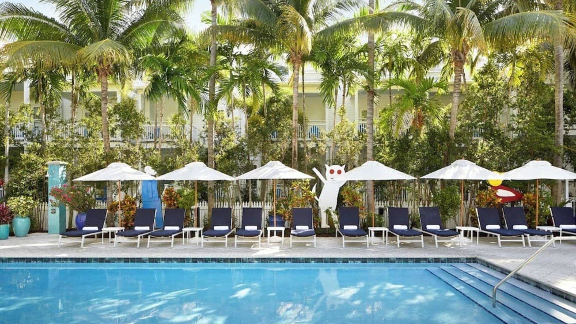 Outdoor pool with loungers at Parrot Key Hotel & Villas.
