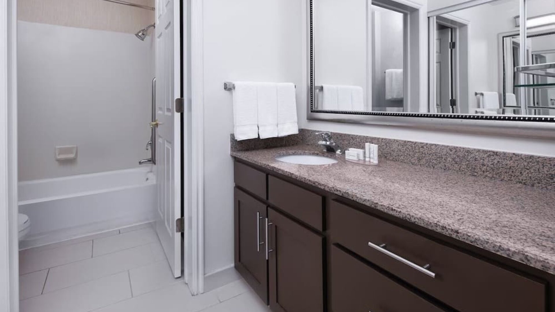 Guest bathroom with shower and tub at Residence Inn By Marriott Provo.