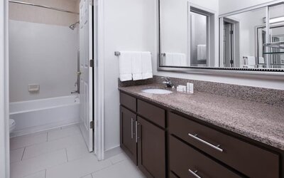 Guest bathroom with shower and tub at Residence Inn By Marriott Provo.