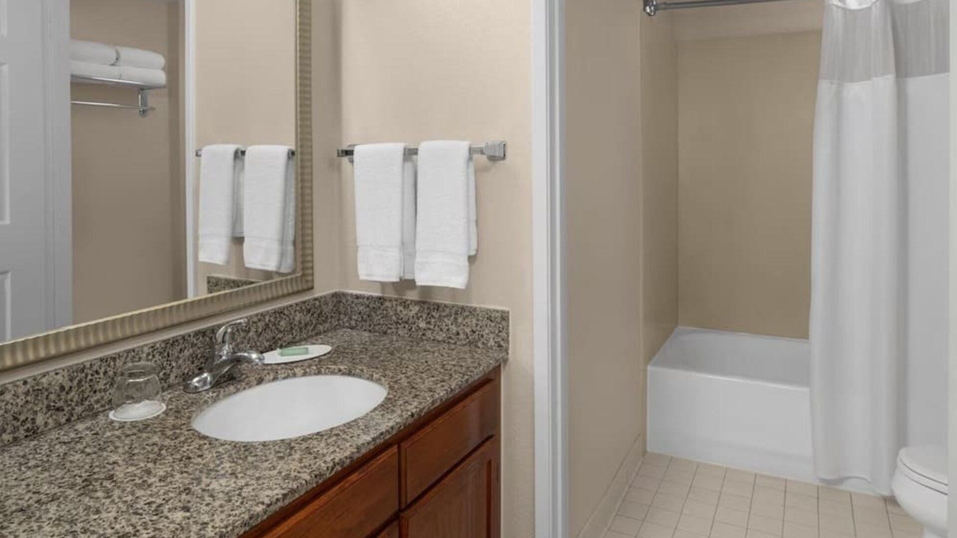 Guest bathroom with shower and tub at Residence Inn By Marriott San Diego Downtown.