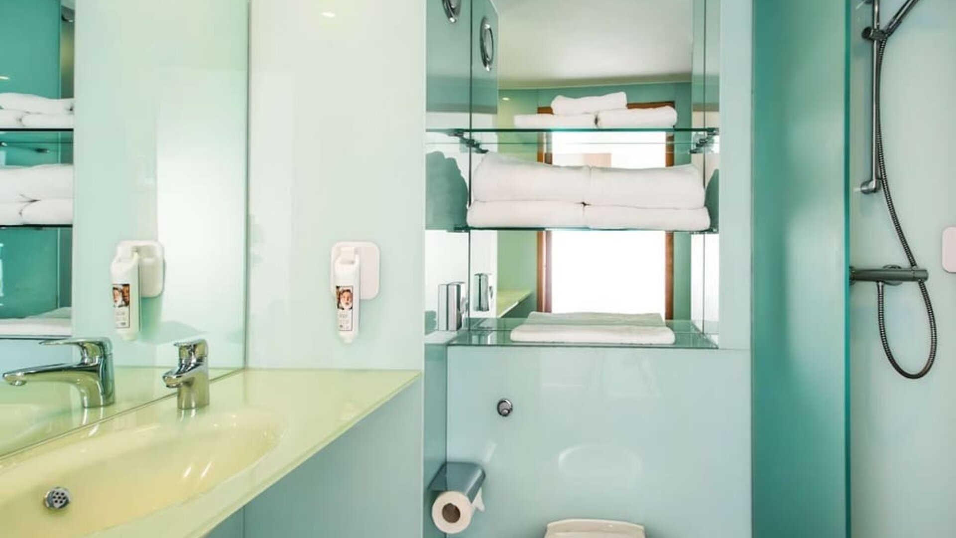 Guest bathroom with shower and free toiletries at ibis Styles Birmingham NEC.