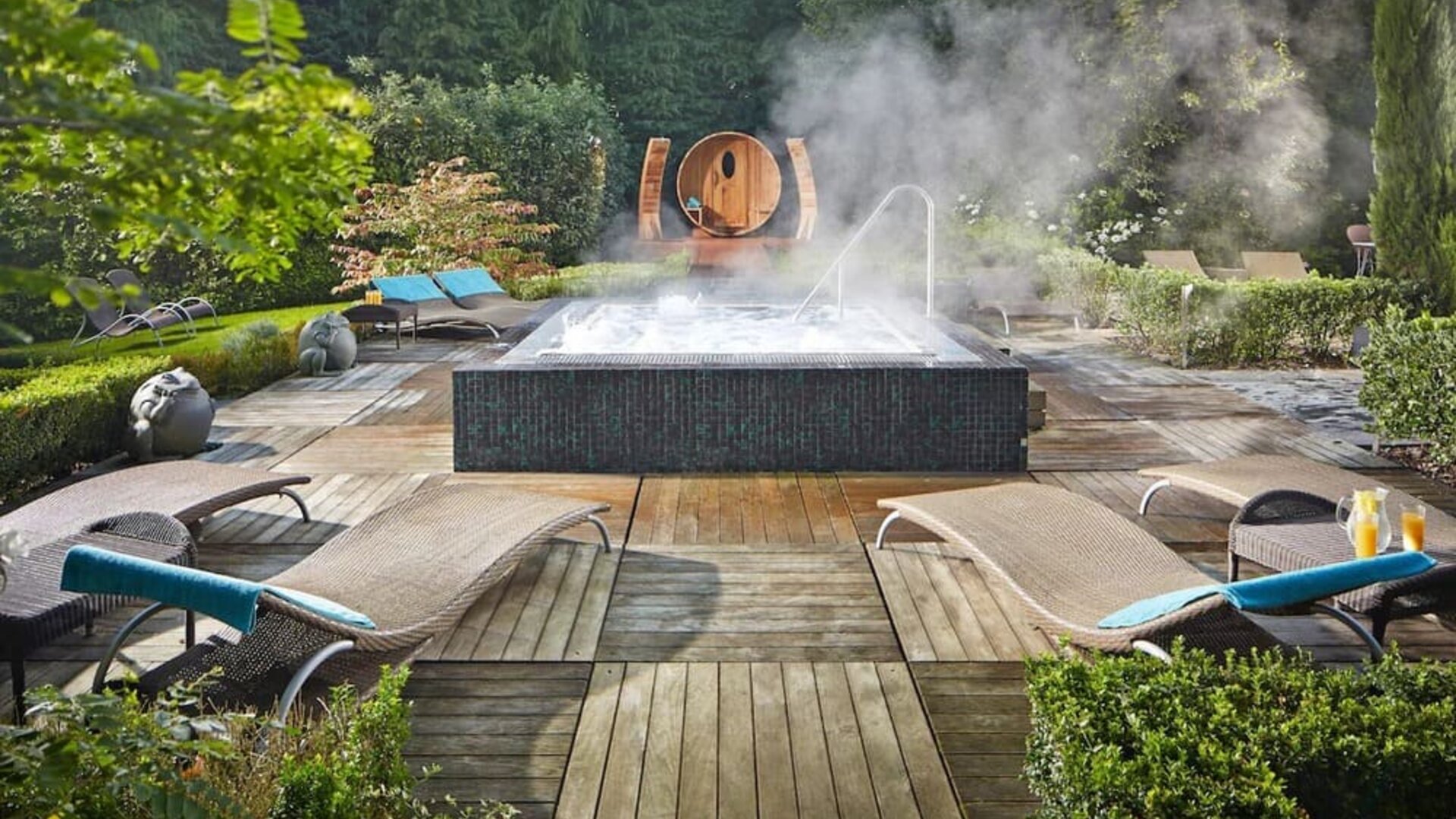 Relaxing outdoor jacuzzi with lounge chairs at Alexander House Hotel And Utopia Spa Hotel.