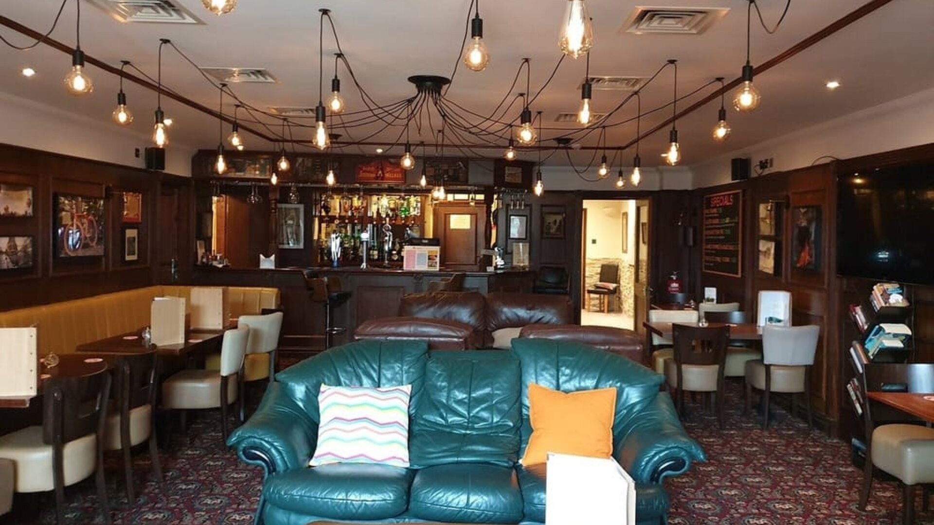 Hotel restaurant and bar with comfortable seating at Gatwick Belmont Hotel.