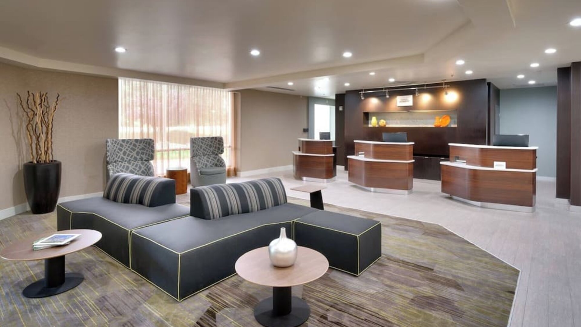 Lobby and coworking lounge at Courtyard By Marriott Charlotte Airport/Billy Graham Parkway.