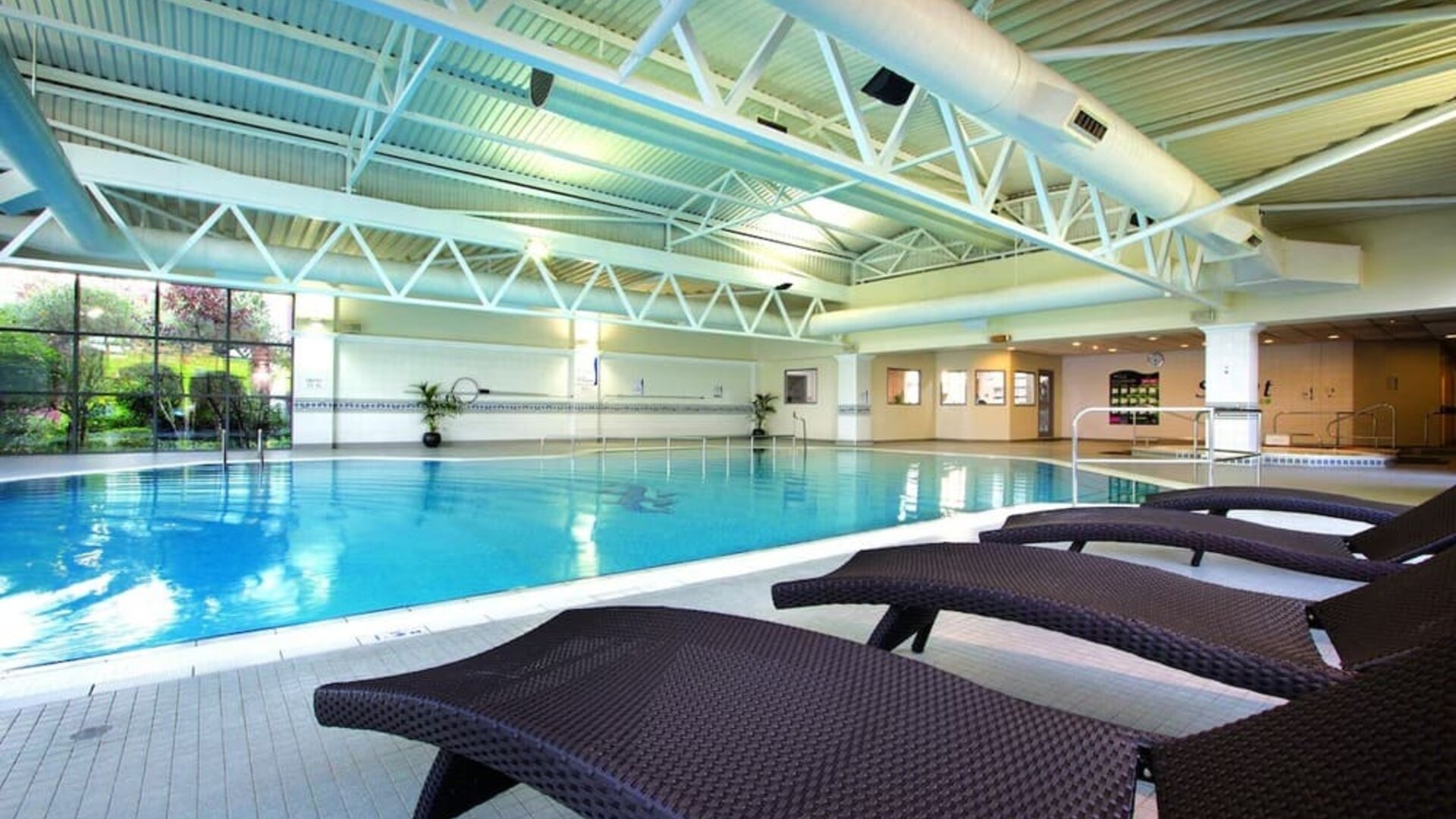 Indoor pool with lounge chairs at Crowne Plaza London - Heathrow.