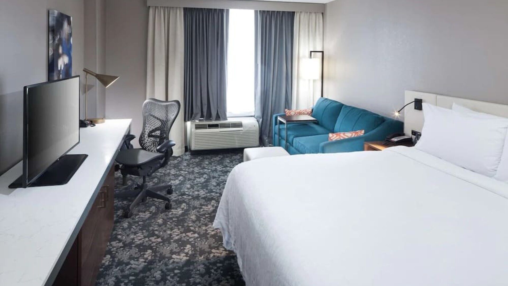 Day use room with work desk and sofa at Hilton Garden Inn Nashville Vanderbilt.