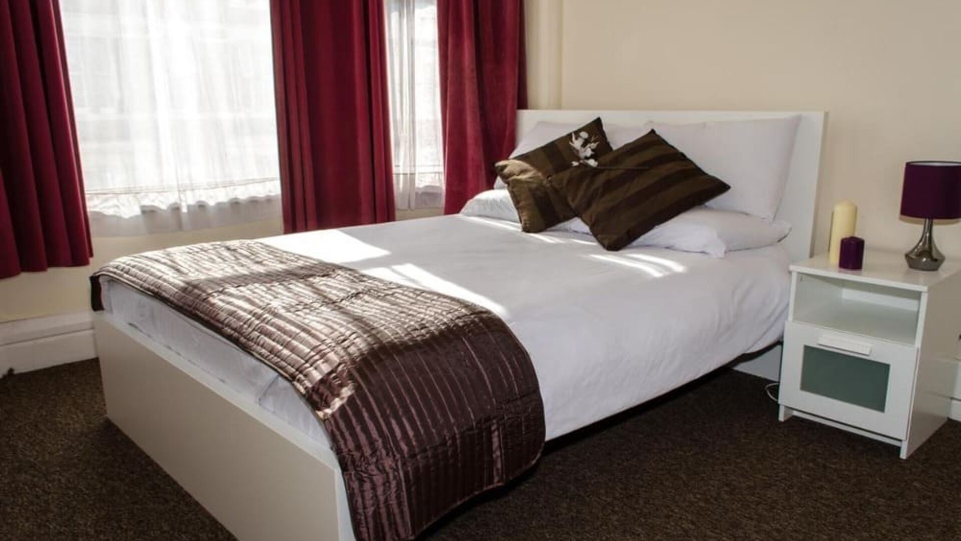 King bed at Campbell Guest House Hotel.