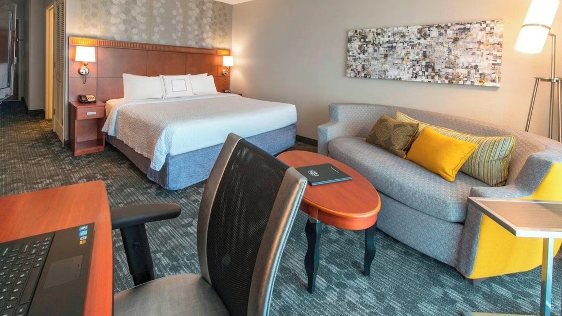 Day use room with work desk and sofa at Courtyard By Marriott Montgomery Prattville.