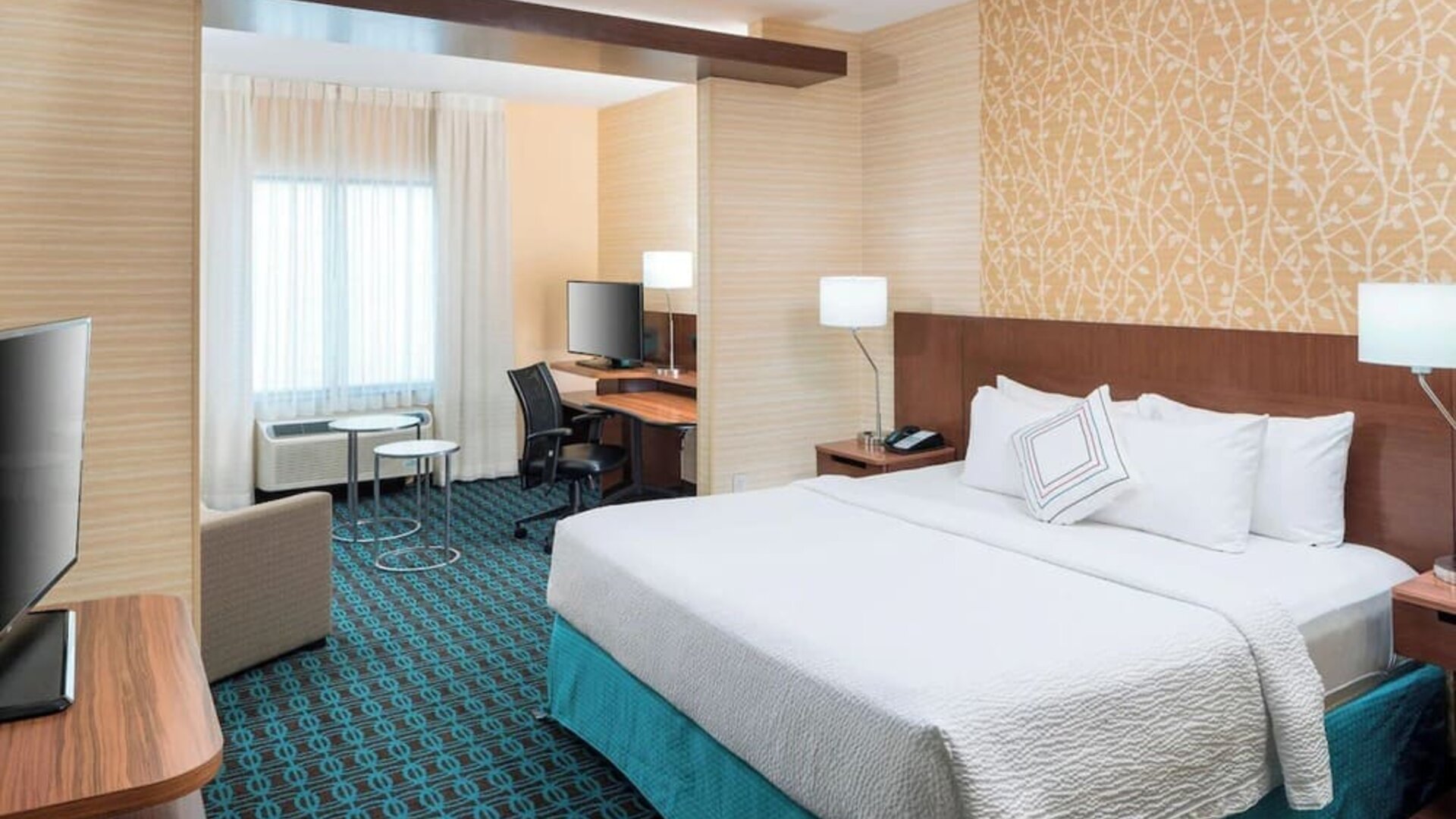 Day use room with work desk and sofa at Fairfield Inn & Suites By Marriott Houston Pasadena.