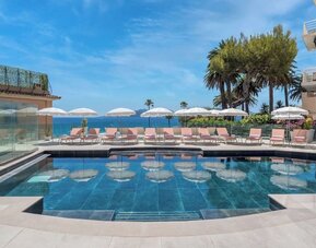Outdoor pool area at Canopy By Hilton Cannes.