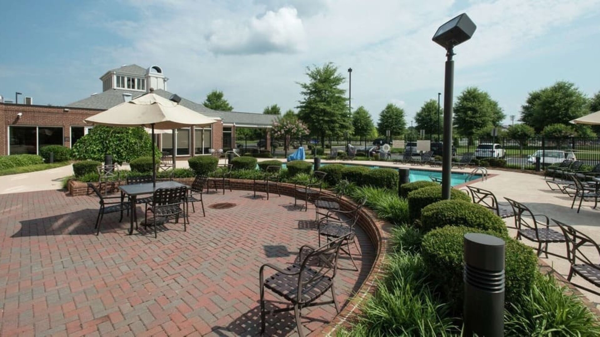 Seats available beside the pool at Hilton Garden Inn Macon / Mercer University.
