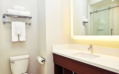 Guest bathroom with shower at Holiday Inn Express & Suites Corona.