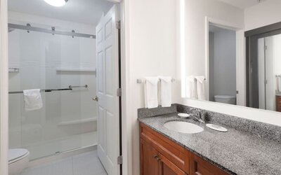 Guest bathroom with shower at Residence Inn By Marriott Bentonville Rogers.