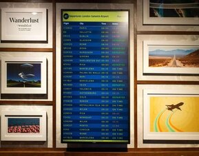 Lobby lounge with departures screen at Ibis London Gatwick Airport Hotel.