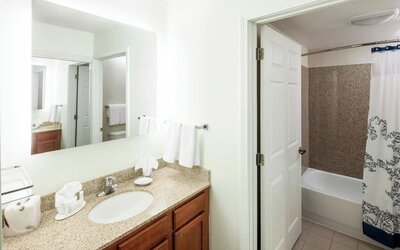 Guest bathroom with shower and tub at Residence Inn Kansas City Overland Park.