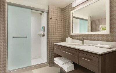 Guest bathroom with shower at Home2 Suites By Hilton Chicago River North.
