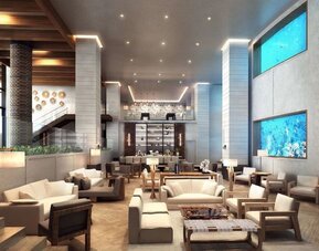 Lobby and coworking lounge beside the oceanarium at Alohilani Resort Waikiki Beach.