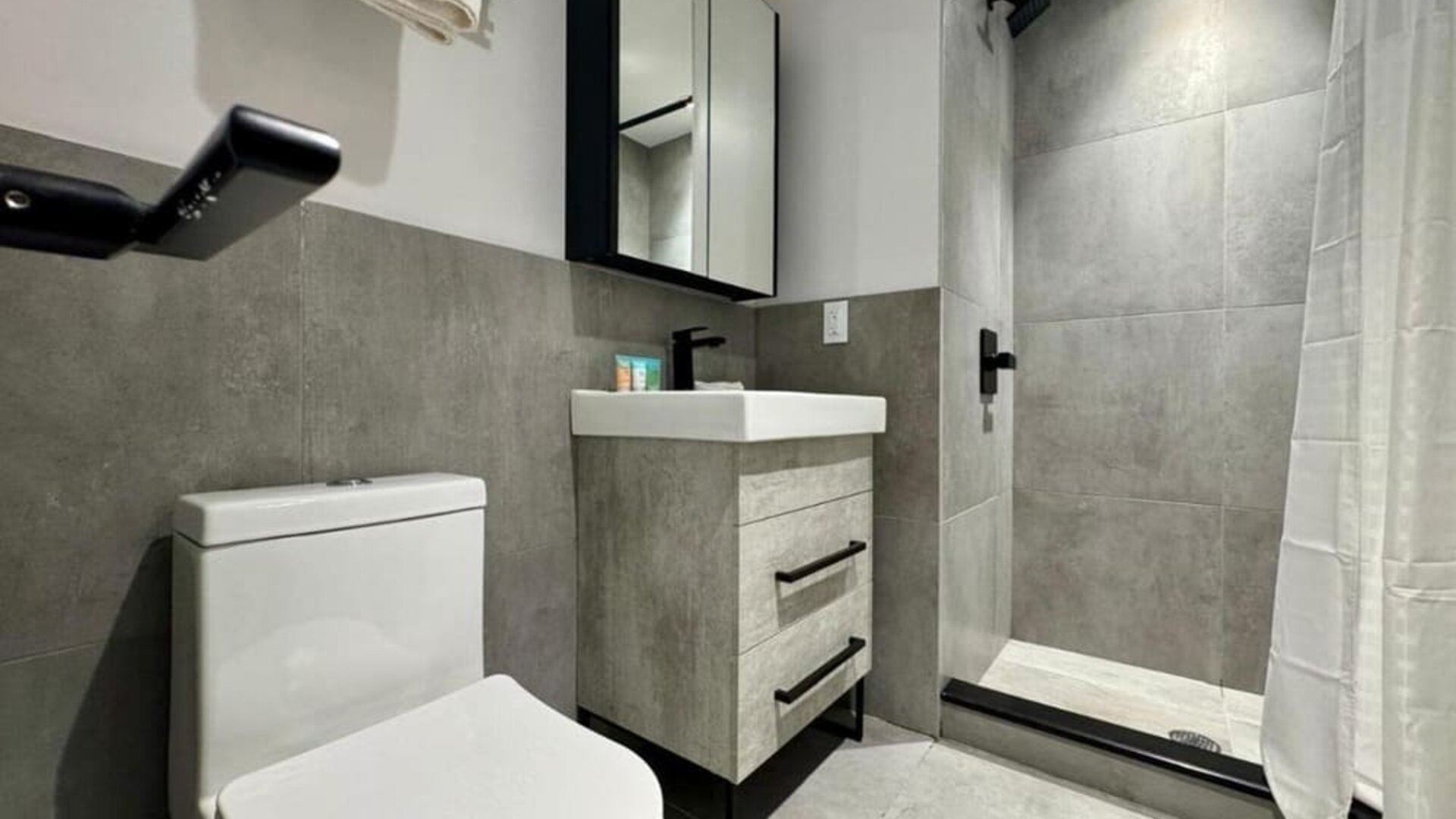 Privte guest bathroom with shower and free toiletries at Rose Hotel, Bronx.
