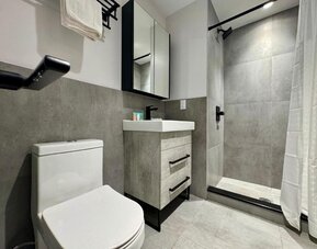 Privte guest bathroom with shower and free toiletries at Rose Hotel, Bronx.