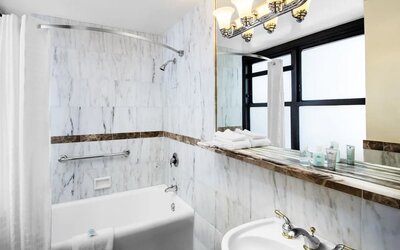 Guest bathroom with shower at The New Yorker Hotel, A Wyndham Hotel.