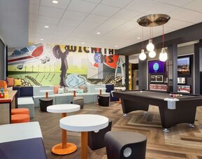 Lobby, coworking lounge and billiards table at Tru By Hilton Wichita Northeast.
