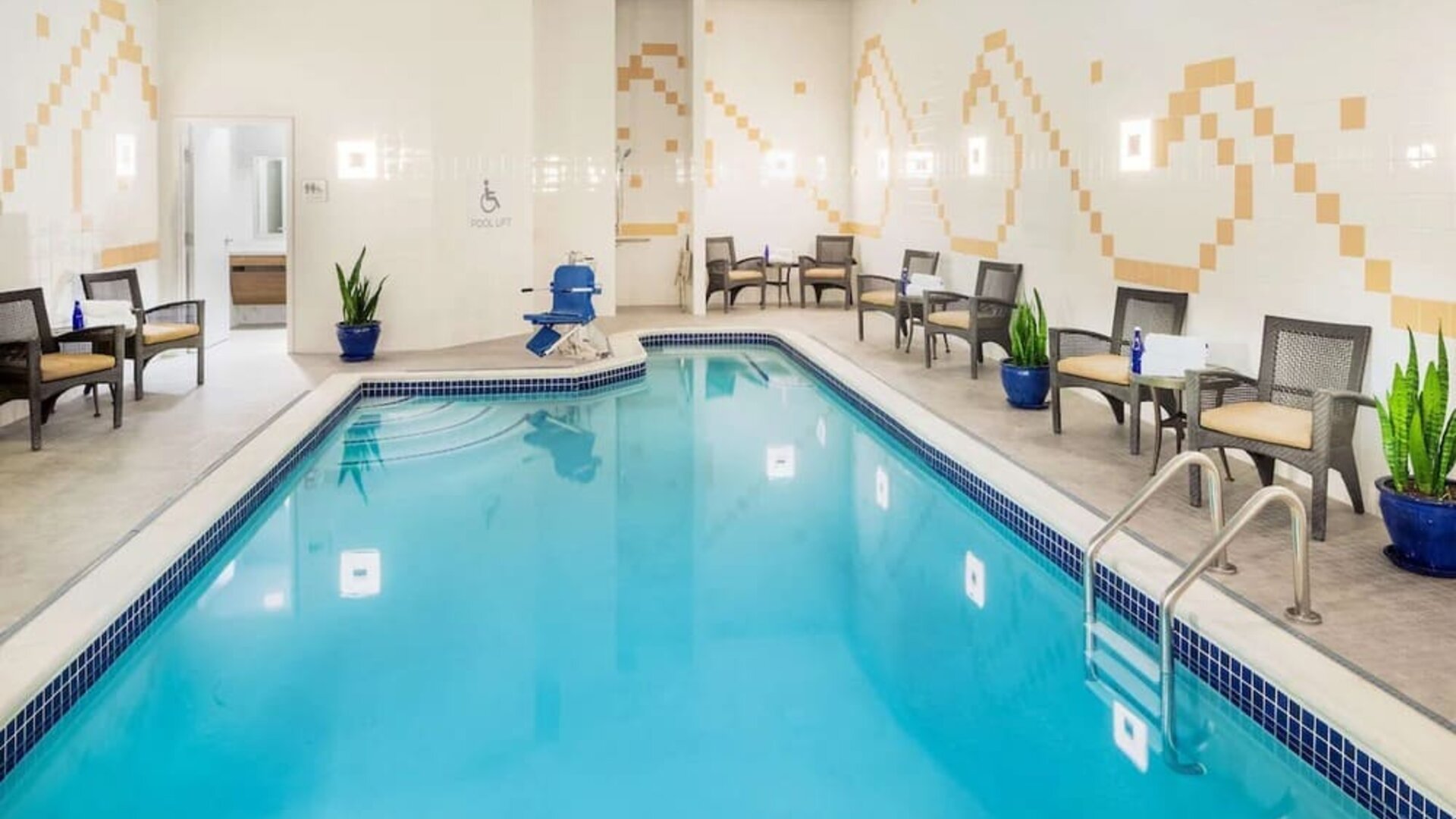 Indoor pool with lounge chairs at Hilton Garden Inn Washington DC Downtown.