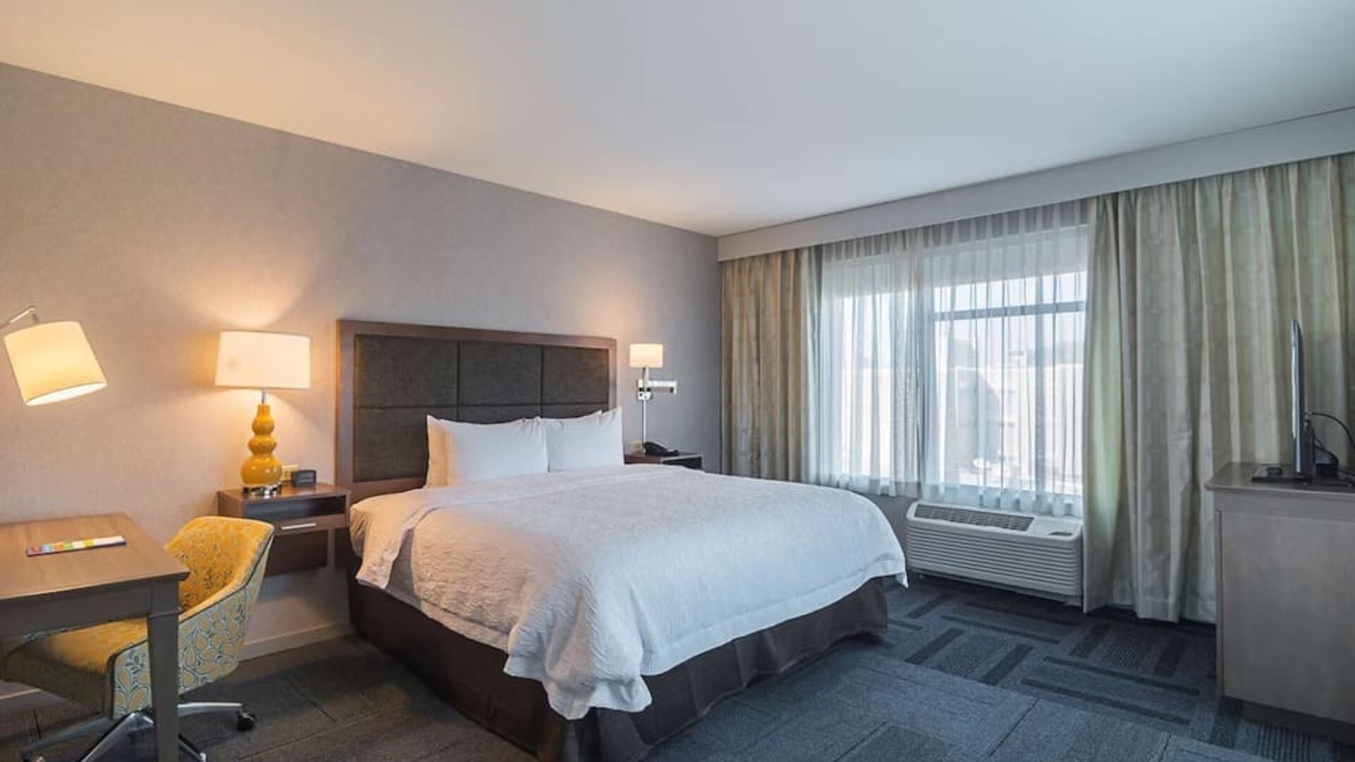 King bed with work desk at Hampton Inn Chicago North/Loyola Station.