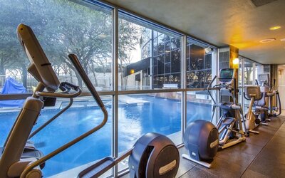Fitness center overlooking the pool at Hilton Dallas Lincoln Centre.