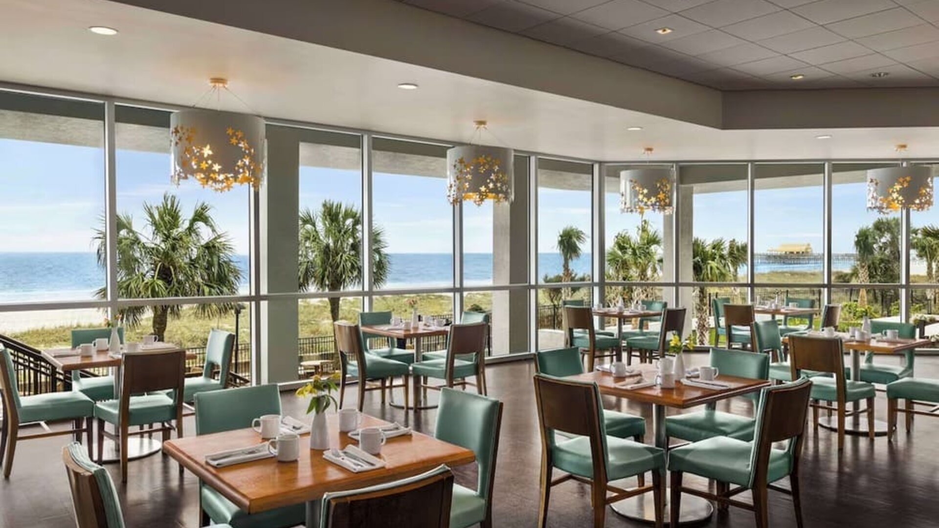 Dining area with natural light perfect for coworking at Embassy Suites By Hilton Myrtle Beach Oceanfront Resort.