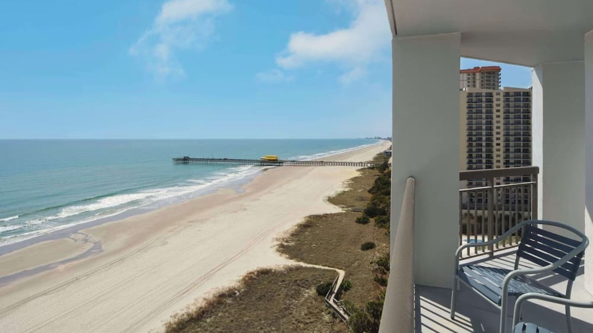 Balcony from day use room overlooking the ocean at Embassy Suites By Hilton Myrtle Beach Oceanfront Resort.