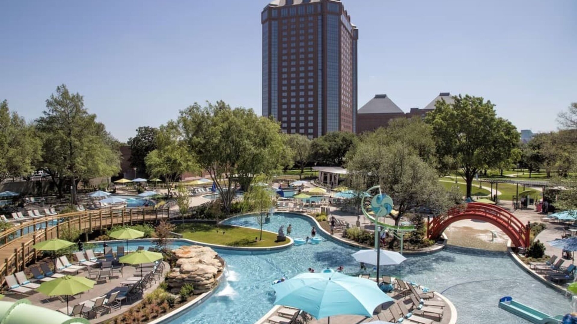 Lazy river, waterslide, and sun loungers available around the outdoor pool at Hilton Anatole.