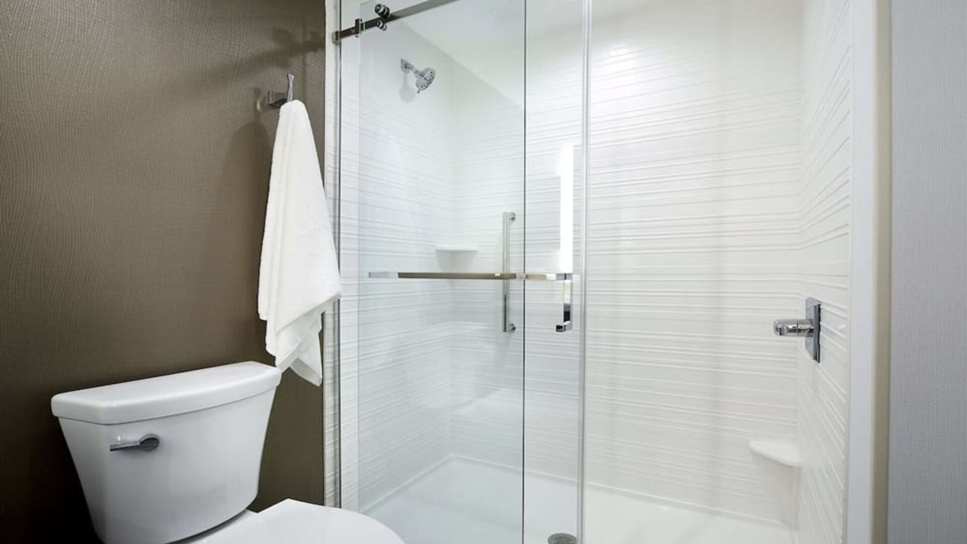 Guest bathroom with shower at Hilton Garden Inn Camden Waterfront Philadelphia.