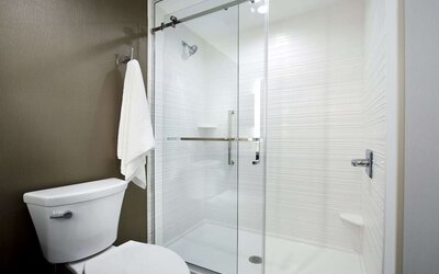 Guest bathroom with shower at Hilton Garden Inn Camden Waterfront Philadelphia.