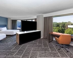 Two queen beds in a spacious day use room with work desk at DoubleTree By Hilton Tulsa - Warren Place.