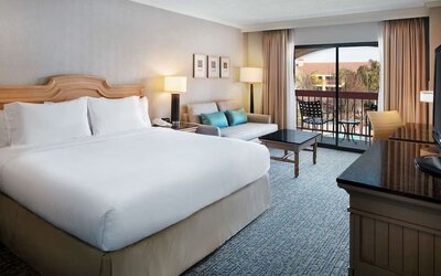 Day use room with work desk, sofa and balcony at DoubleTree By Hilton Sonoma Wine Country.
