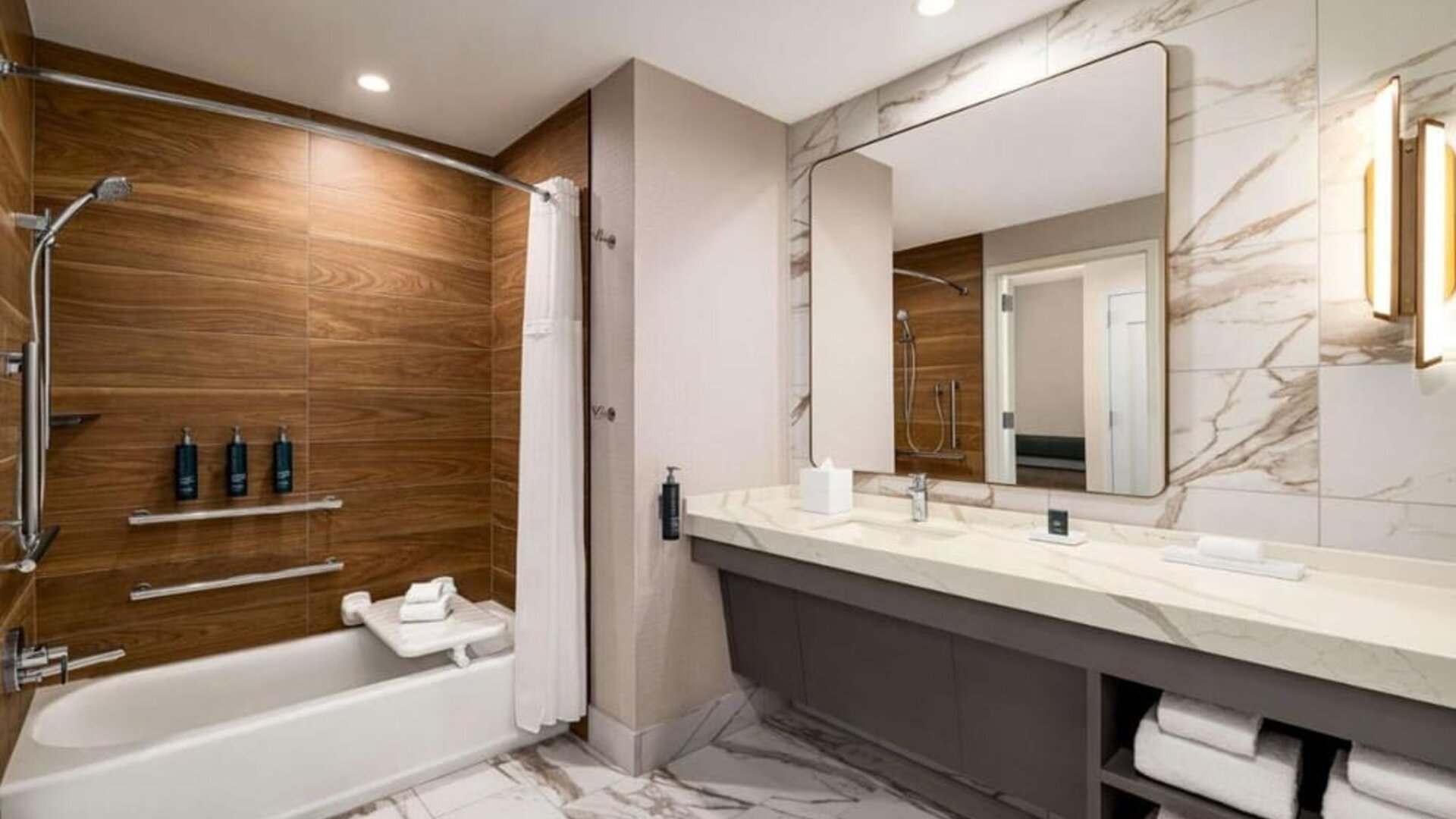 Private guest bathroom with tub at Hilton BNA Nashville Airport Terminal.
