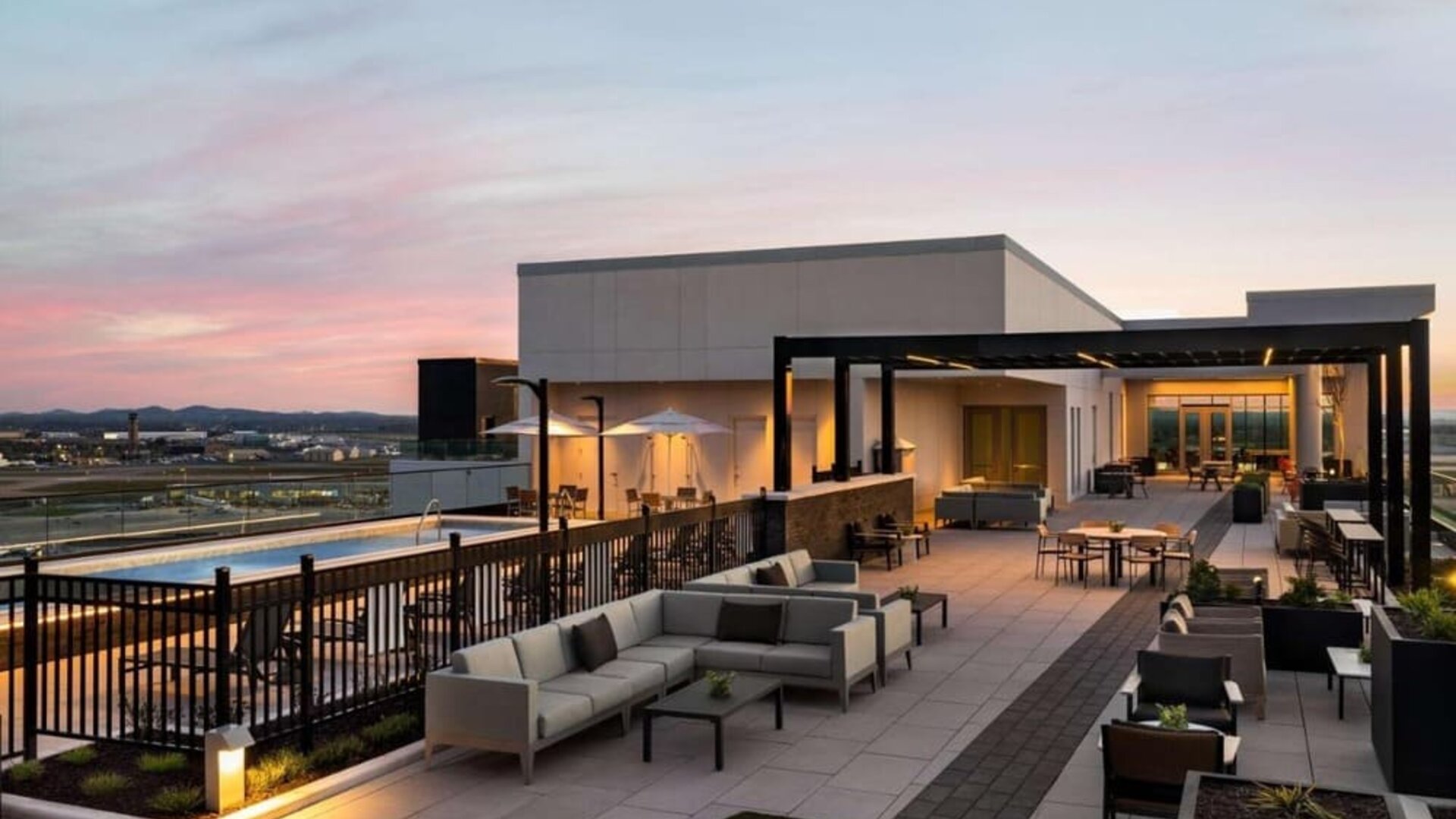 Hotel rooftop with lounge area and pool at Hilton BNA Nashville Airport Terminal.
