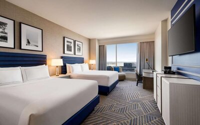 Day use room with two beds and workdesk at Hilton BNA Nashville Airport Terminal.
