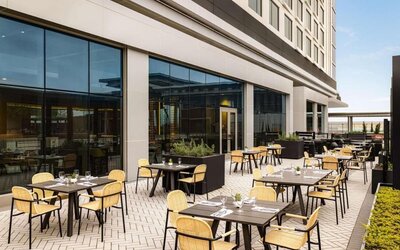 Hotel terrace with seating at Hilton BNA Nashville Airport Terminal.
