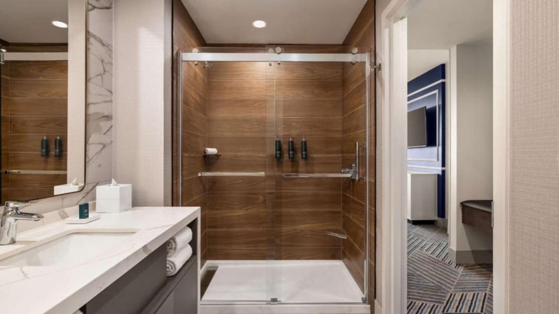 Private guest bathroom with shower at Hilton BNA Nashville Airport Terminal.
