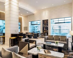 Hotel lobby with comfortable seating at Hilton BNA Nashville Airport Terminal.
