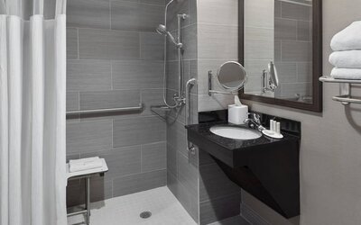 Ptivate guest bathroom with shower at Fairfield Inn & Suites By Marriott New York Staten Island.