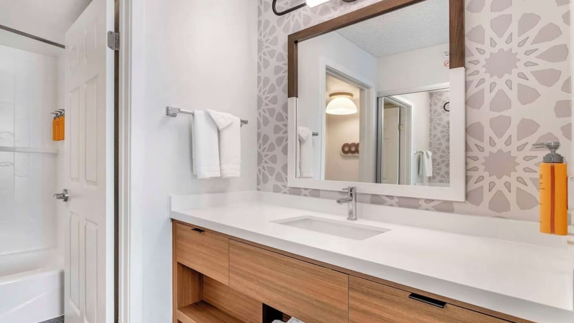 Private guest bathroom with shower and free toiletries at Sonesta ES Suites San Antonio Downtown Alamo Plaza.