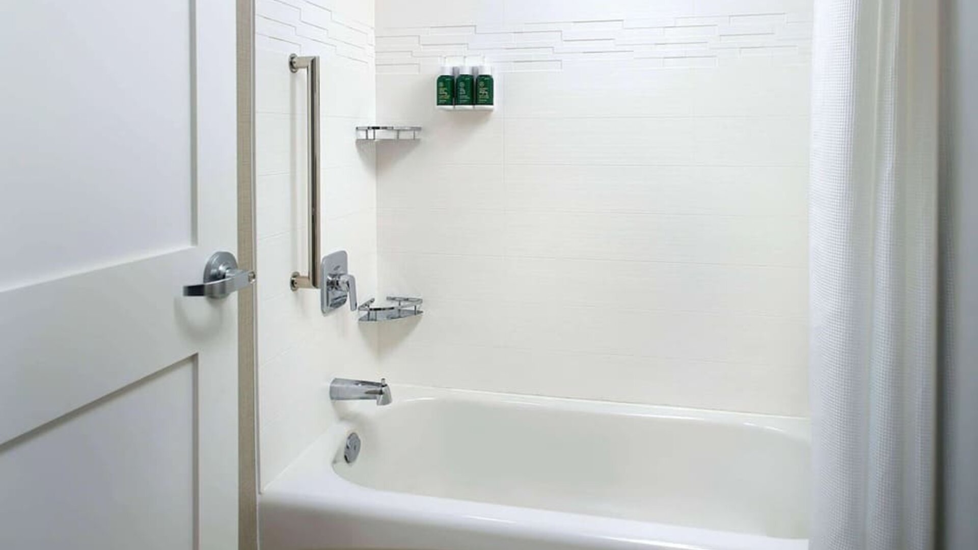 Private guest bathroom with tub and free toiletries at Sonesta ES Suites Raleigh Cary.